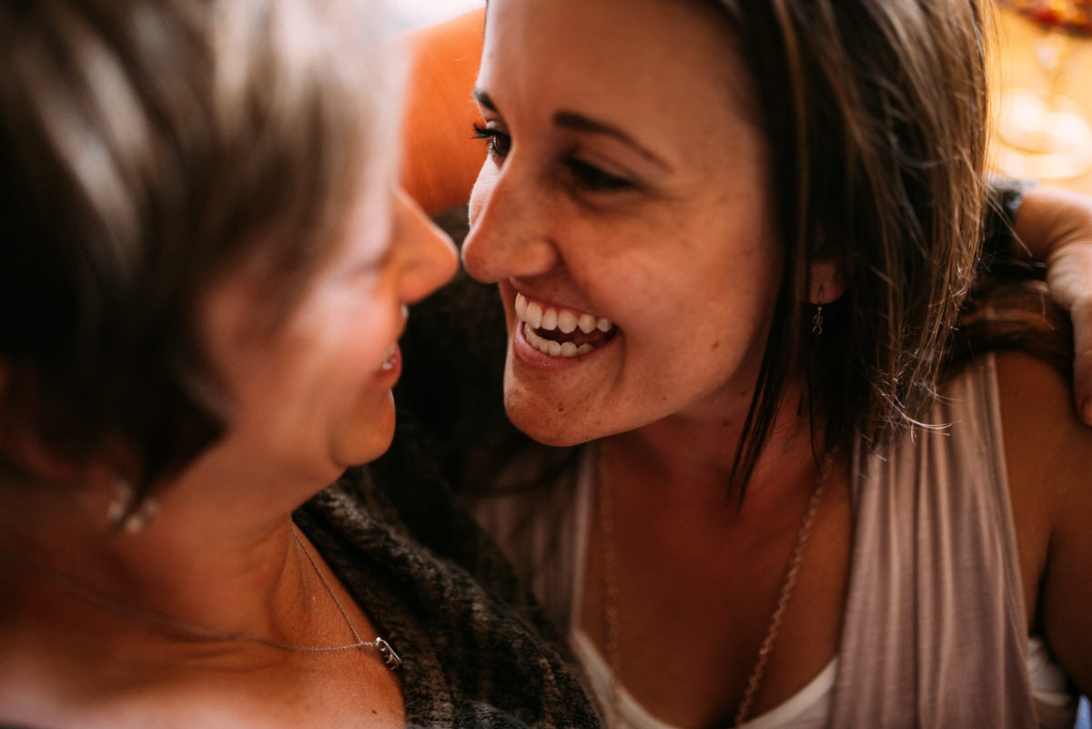 close up of two women laughing at each other